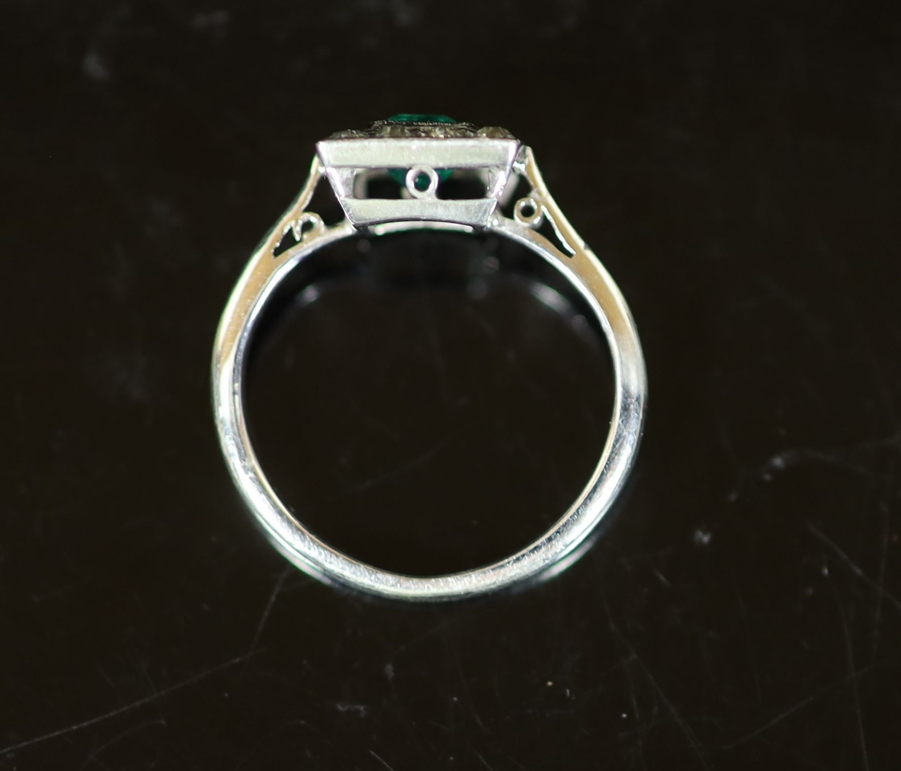 A 1920's platinum, emerald and diamond cluster set tablet ring